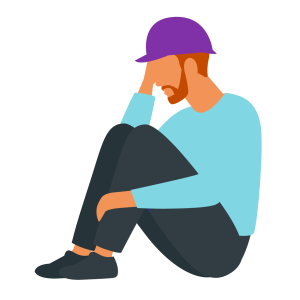 A distressed construction worker in a purple hard hat sits with his knees drawn up, resting his head on one hand.